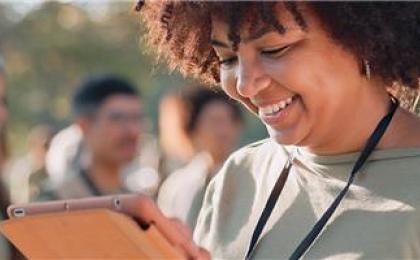 Young female charity worker looking at clipboard