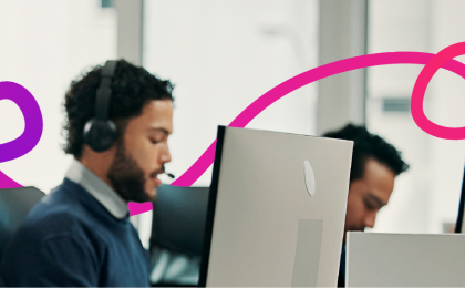 team of people looking at a laptop in an office