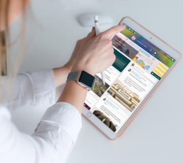 Woman on iPad using People First social feed