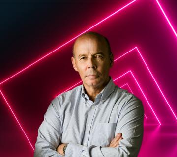 sir clive woodward with neon pink squares on black background