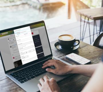Person on People First Connect Remote Workforce Management check-ins on laptop with coffee