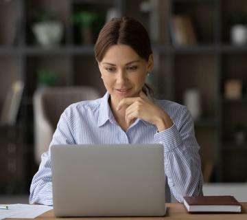 Woman looking at laptop at home