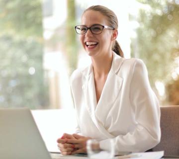Woman sitting at laptop smiling