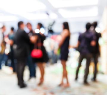 group of people at a networking event, blurred