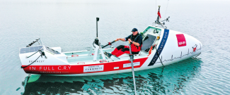 Row for Amy sponsorship, showing Mr Osborne in the boat on the water.