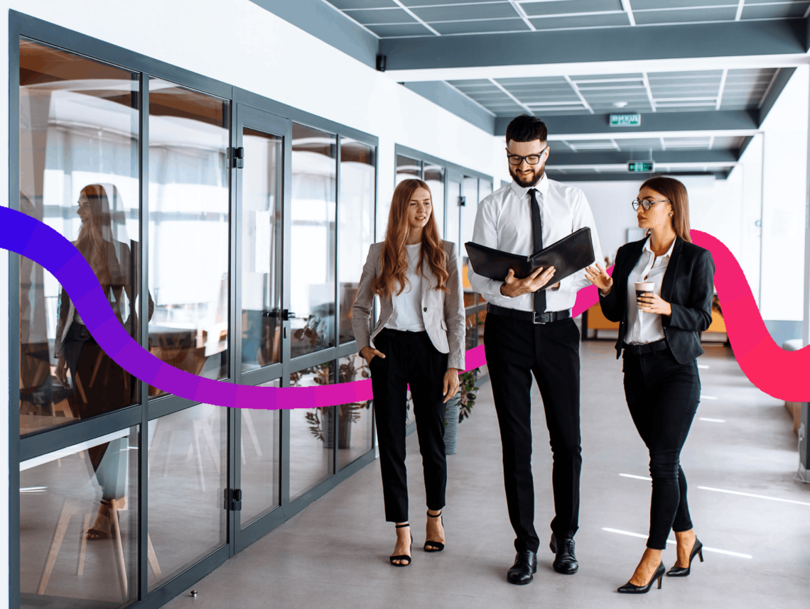 3 people walking in an office