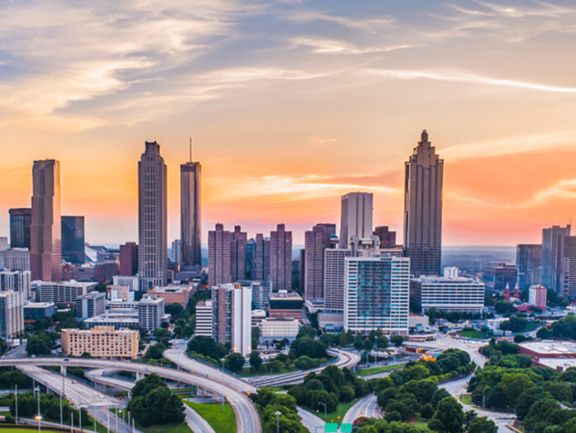 Downtown Atlanta skyline at sunset with highways in the foreground 