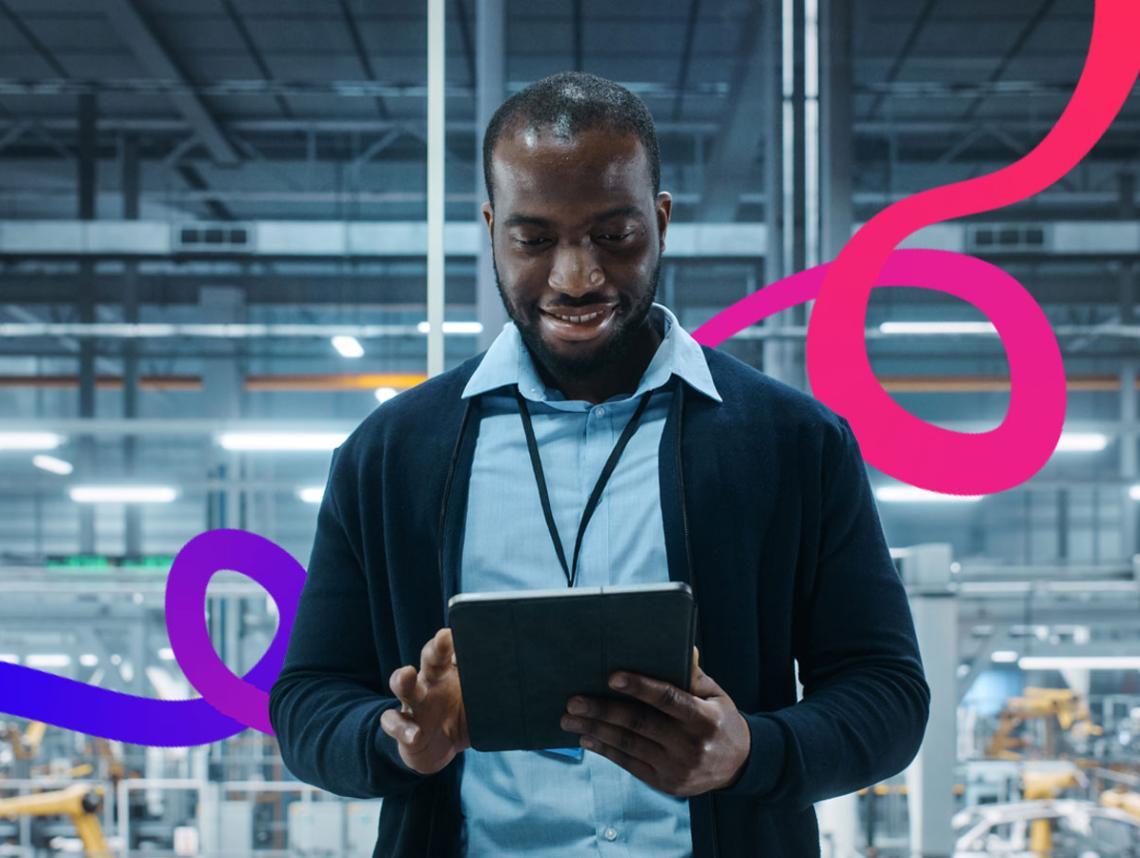 Man stood in a warehouse with an iPad