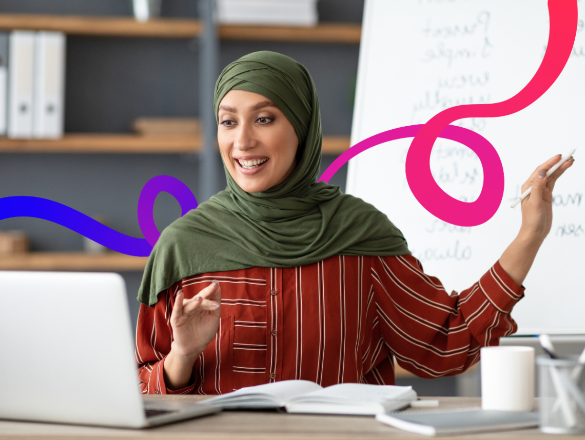 A woman with a hijab working on a laptop 