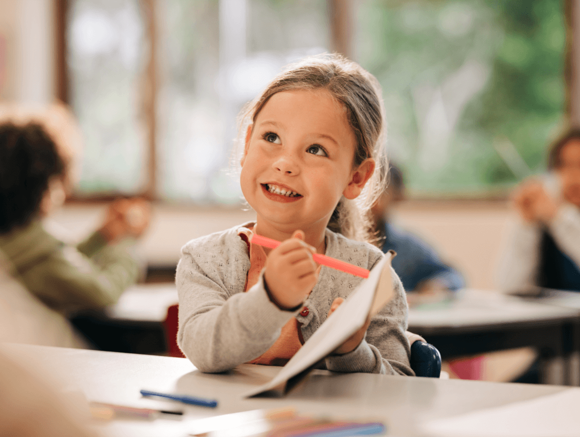 A young girl showing a workbook