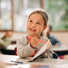 A young girl showing a workbook