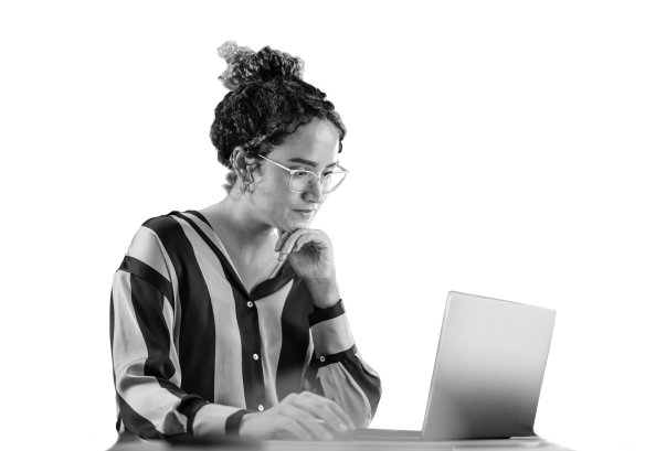 A lady with glasses, working on a laptop.