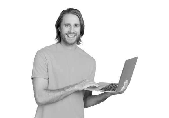A man smiling with a laptop