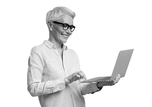 Woman smiling whilst holding a laptop and looking at the screen.