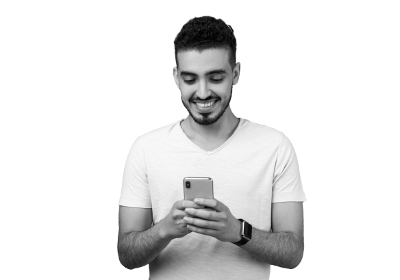 A man looking down, smiling at a mobile.