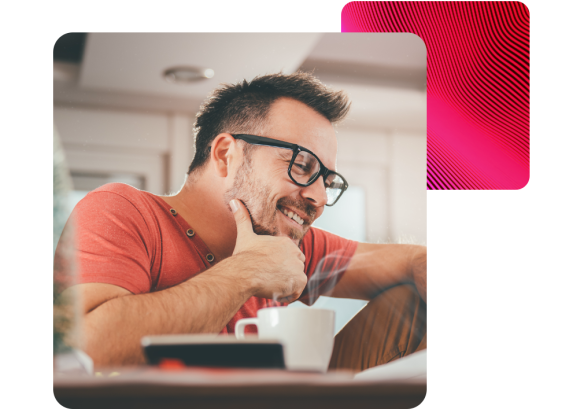 man with glasses leaning on desk