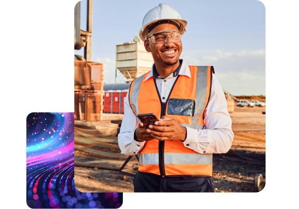 a man on a construction site, wearing a high vis and a hard hat. checking on his schedule with people first hr software.