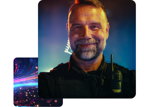 Portrait of a male police officer lit by the lights of squad cars