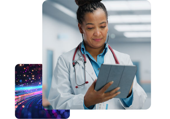 Female healthcare worker with a stethoscope around her neck, accessing MHR software on her tablet