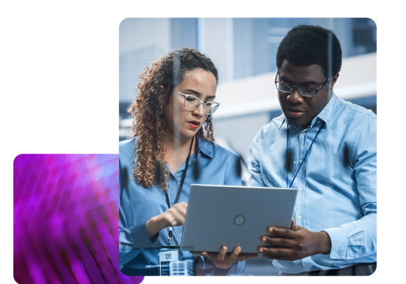 A man and a woman looking at a laptop collaborating over payroll software.