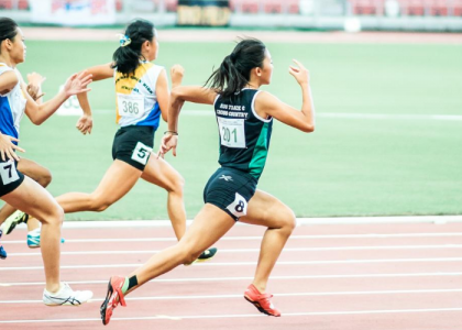 Female runners racing on a race track