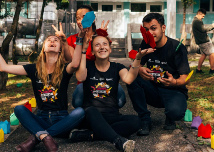 Three people looking very happy to be volunteering and giving back to the community