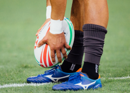 Rugby ball and player about to kick it