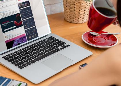 Lady working remotely at a laptop screen with People First on it