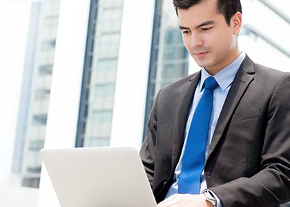 Man sitting at laptop screen at work