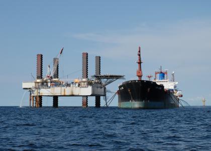 An oil rig and boat owned by Perenco pictured in the ocean