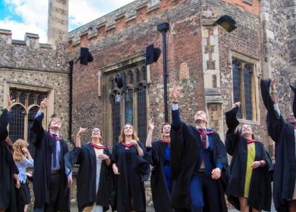 University graduates throwing their caps in the air.