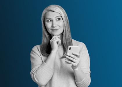 A lady thinking, with a mobile in her hand.