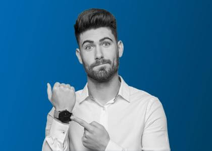 A man pointing to his watch.