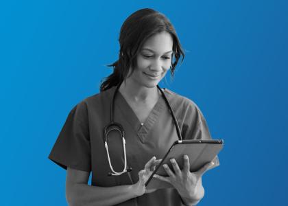 a doctor holding an ipad, managing the team through MHR's people first talent management software for healthcare.