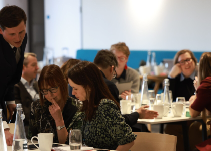 people around a table engaged in conversation