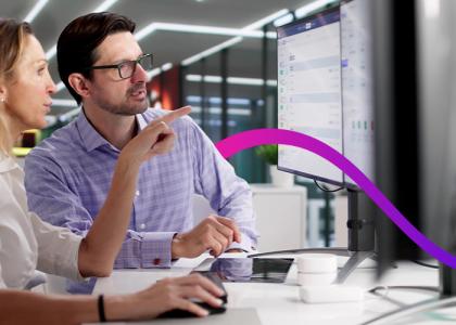Man and woman looking at computer having a conversation