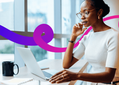 Woman sat at a desk on her laptop