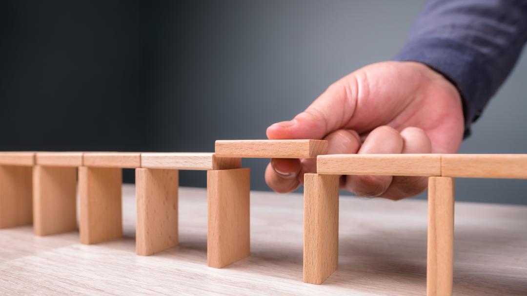 Wooden blocks with a gap in the middle, representing skills gaps in organisations
