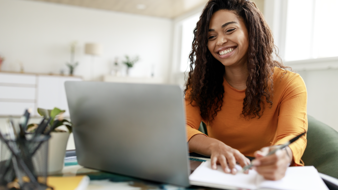 Woman sat at home, learning via her laptop