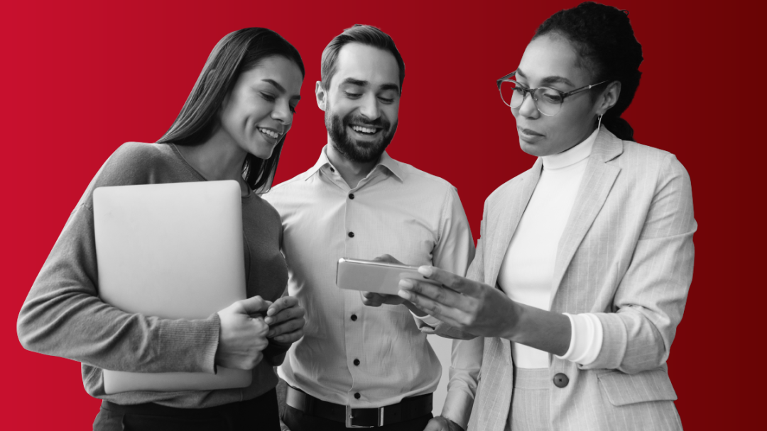 A group of three employees looking at a mobile and tablet screen for People First and iTrent.