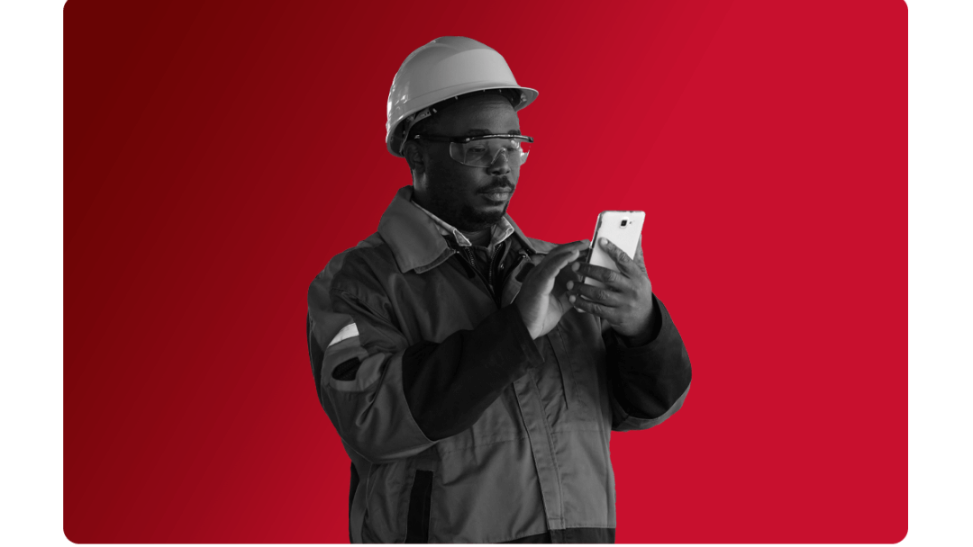 Employee on site looking at his phone, by using People First he stays connected to the wider workforce.