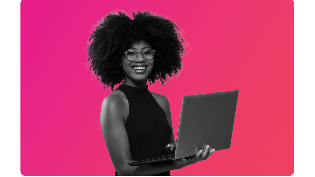 A lady with glasses on smiling holding a laptop, looking at vital insights MHR's analytics integration gives them.