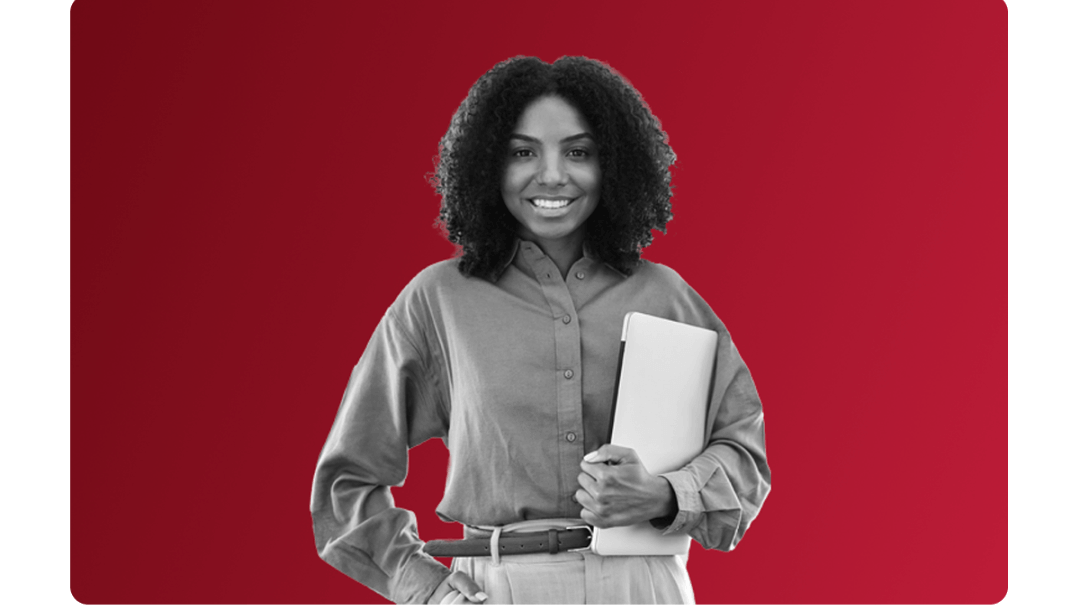 A lady smiling holding a laptop.