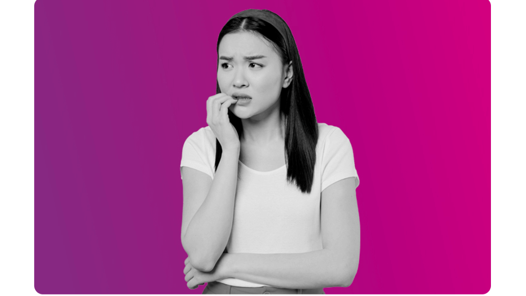 A lady looking worried, biting her nails.