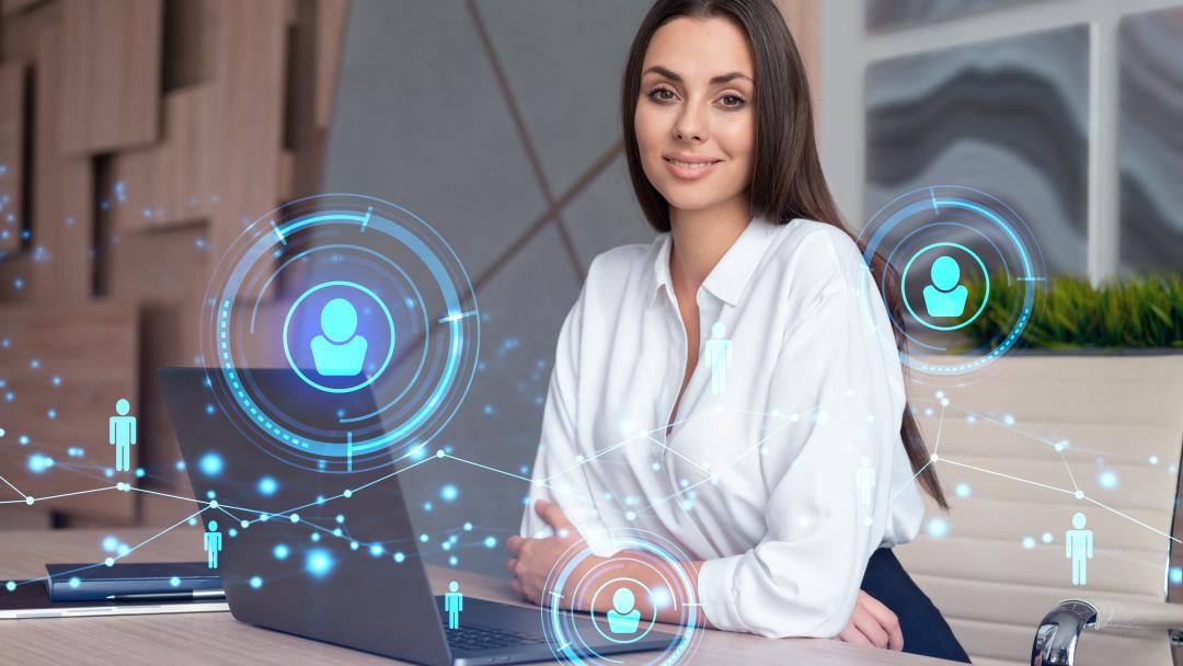 A lady sat behind a laptop, working on ai in recruitment.