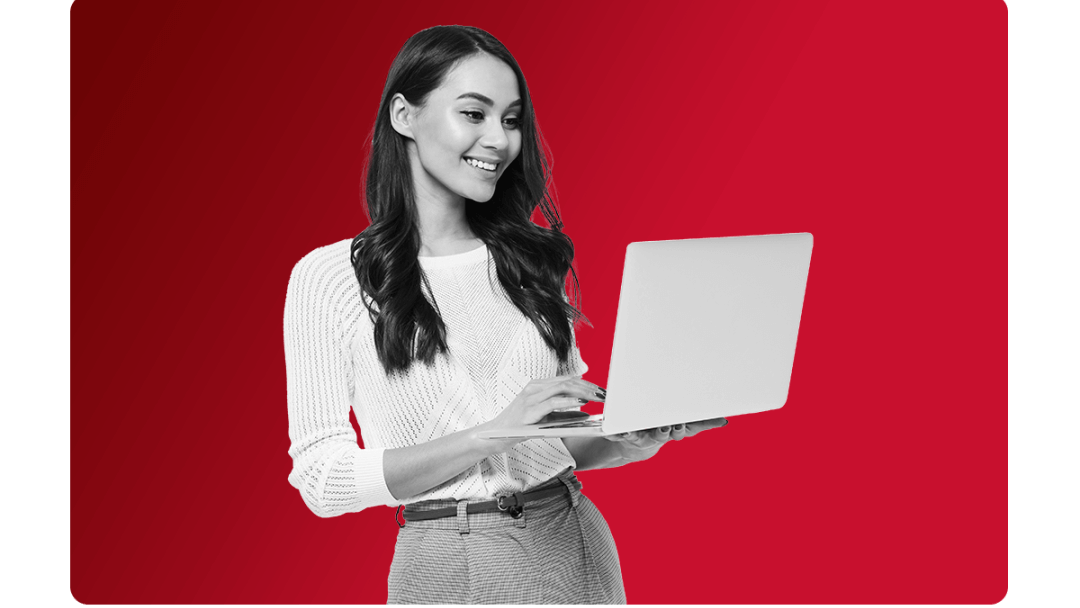 a lady standing up working on a laptop. digitally tranforming company processes with mhr people first's hr and payroll software.