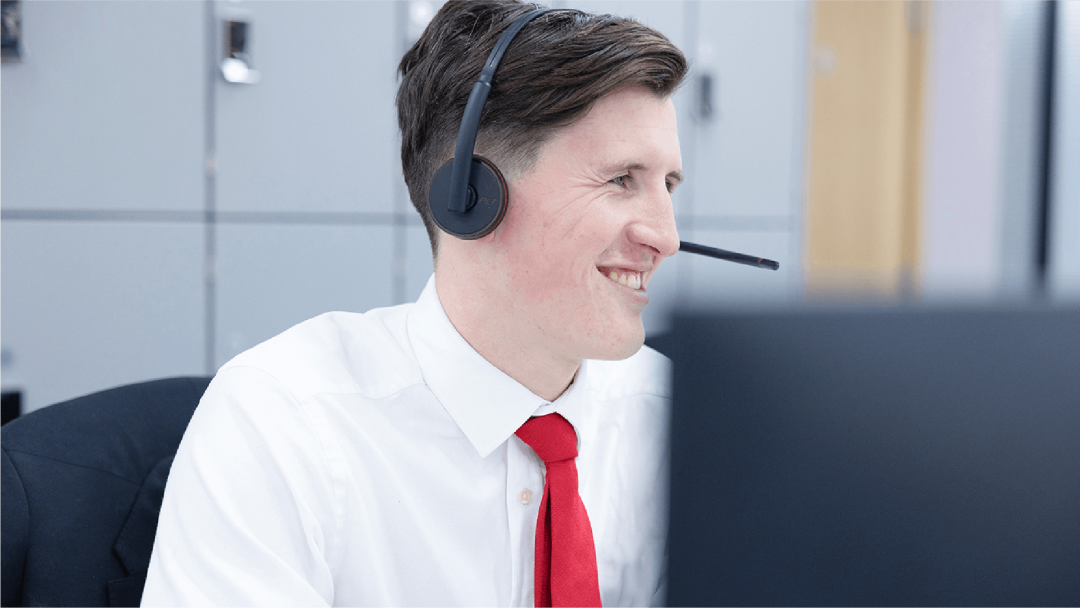 Customer support advisor wearing a headset and assisting a customer