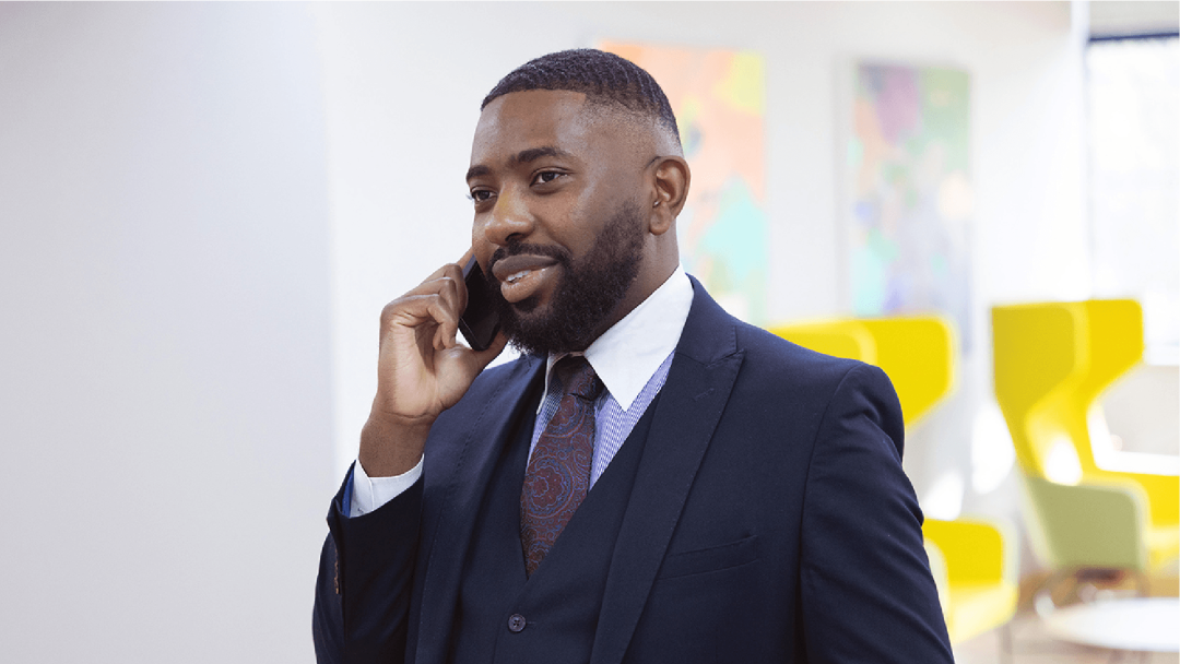 Business professional speaking on a mobile phone in the office