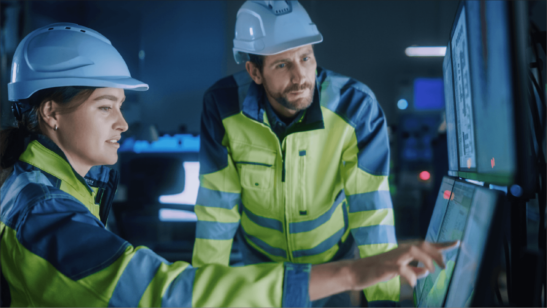 Manufacturing employees reviewing operational data on a production floor