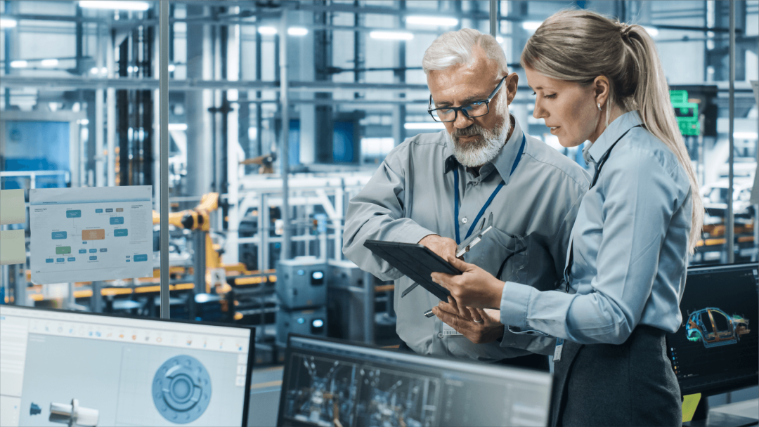 Professionals collaborating in a manufacturing facility using a digital device